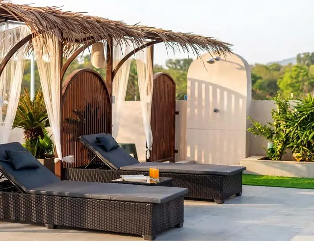 Daybeds under the thatched cabana