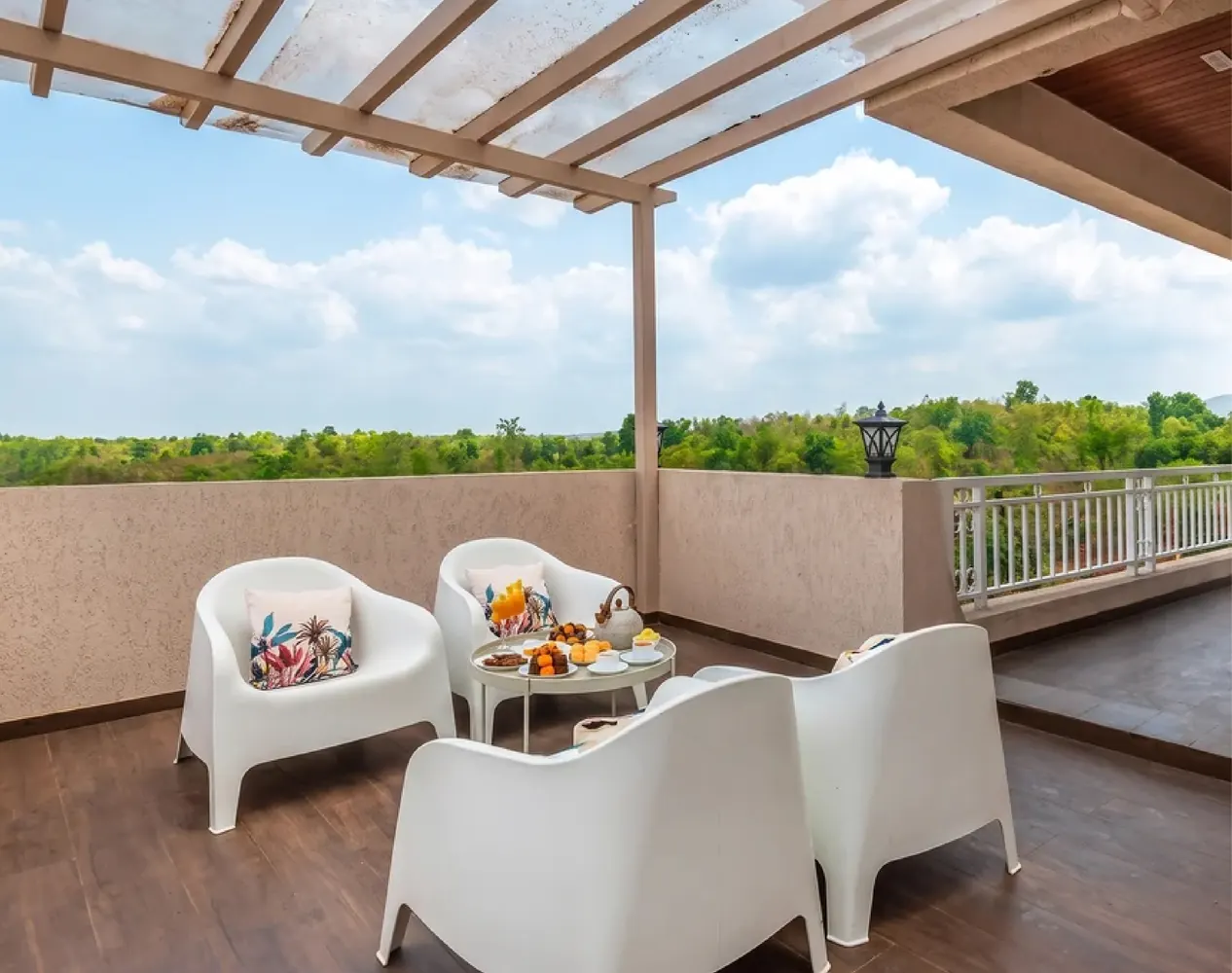 The covered terrace at The Morning Star, laid for tea, looking onto the tree line