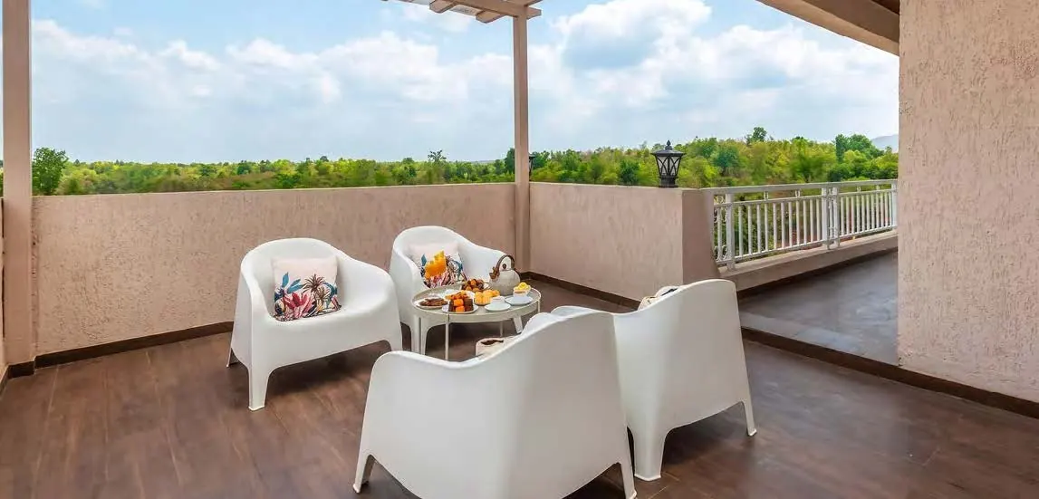 Covered terrace with seating overlooking green valley